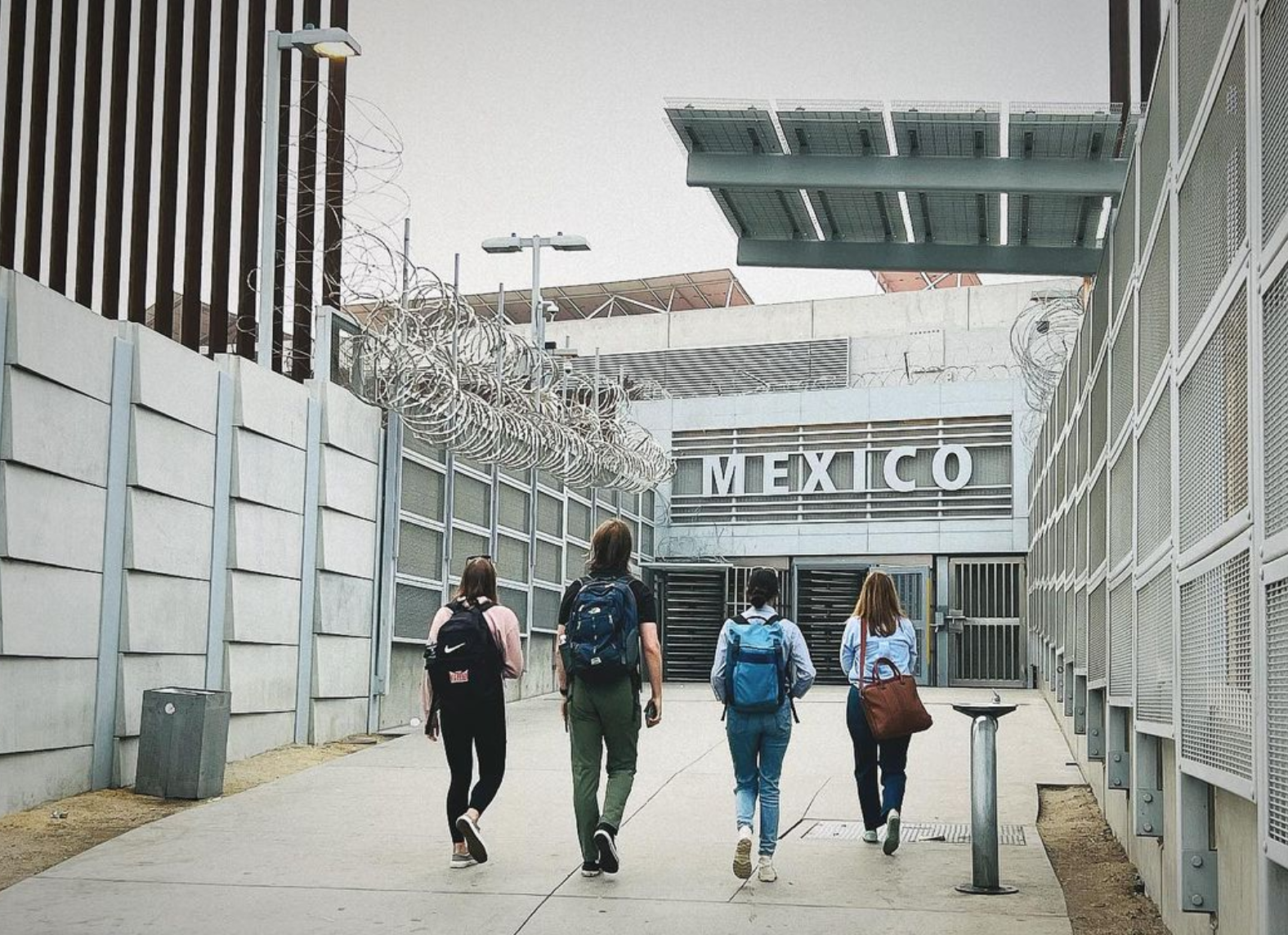 Four people walking into a building labeled "Mexico"